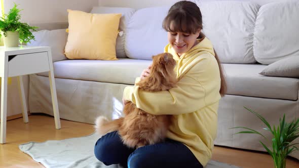 Pretty Young Woman with Cute Cat at Home