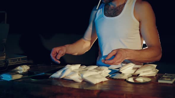 Drugs addict or drug dealer with packages of heroin or cocaine. Criminal business alt