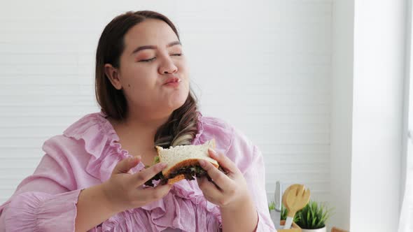 Happy Fat woman eating a sandwich salads for dieting weight loss.