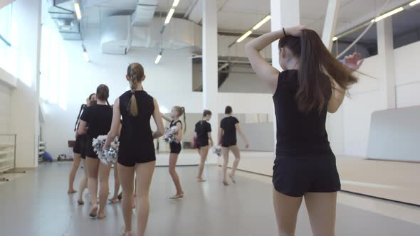 Girls Walking into Gym for Cheerleading Practice alt