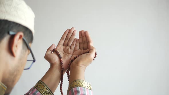 Muslim Man Keep Hand in Praying Gestures During Ramadan Close Up alt