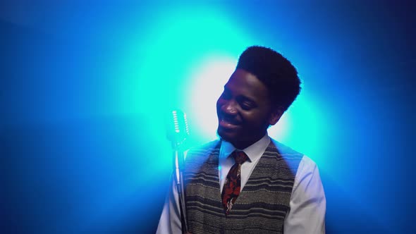 African American Man in a Stylish Suit Sings a Song Into a Retro Microphone alt