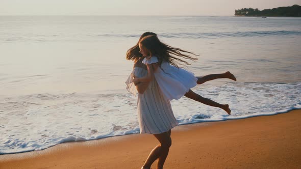 Amazing Family Look of Happy Beautiful Mother and Little Daughter Spinning Together alt