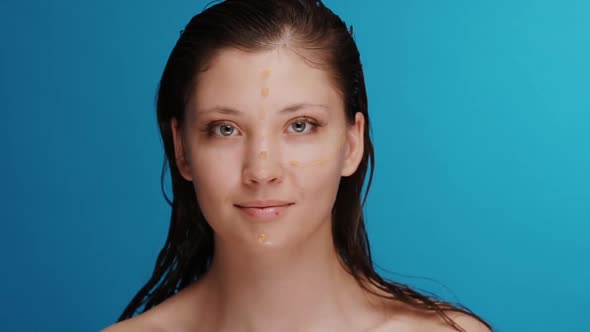 Pretty Girl with Wet Hair and Yellow Marks for Plastic Surgery Smiling To Camera alt