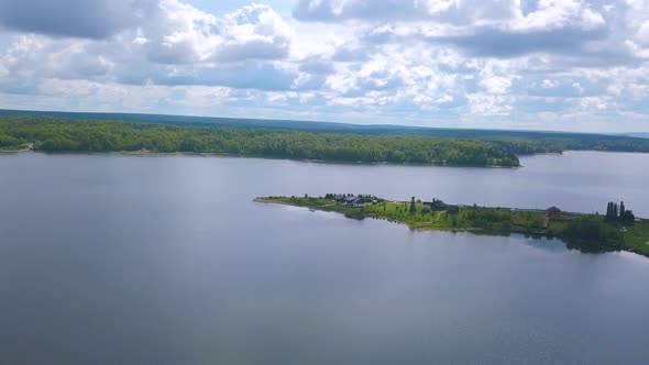 A huge lake against a background of green forest alt