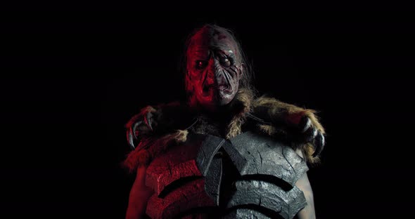 Portrait of a Scary Orc Lifting Up the Sword Near His Face,  alt