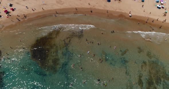 Drone Flies Over the Sea and Tourist Enjoying of Summer Vacations on Beach