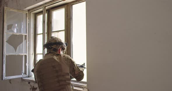 Modern Warfare Soldier in Action Near Window Changing Magazine and Take Cover alt