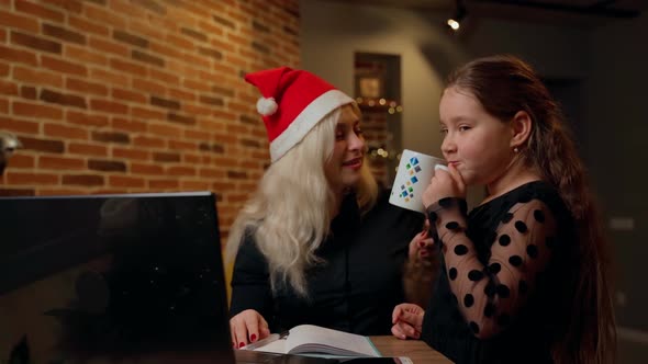 Females spending time together on christmas at living room indoors. Child and adult woman