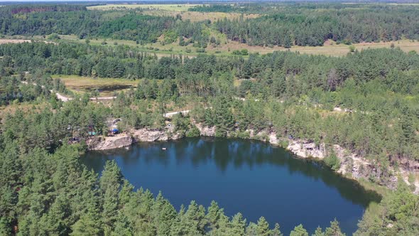 Aerial drone video of people swimming in a lake on a summer day in Kyiv Ukraine. Filmed on a summer alt