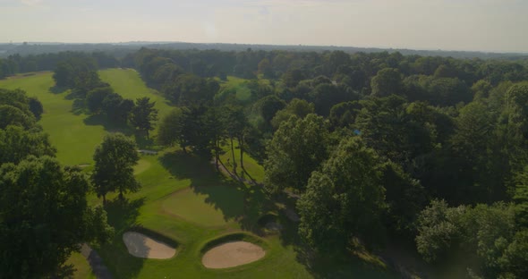 Flying Over Bunker and a Golf Course with Trees in Glen Head Long Island alt
