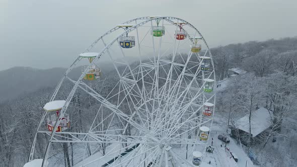Ferris Wheel on Top of Mount Akhun During a Snowfall alt