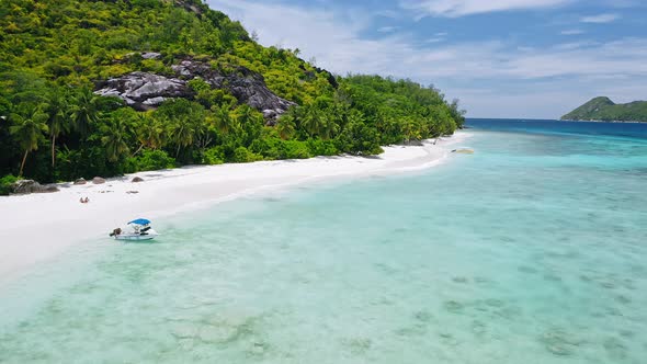 Aerial Footage of Tropical Exotic Beach with Lonely Tourists Relaxing on Perfect White Sand Beach alt