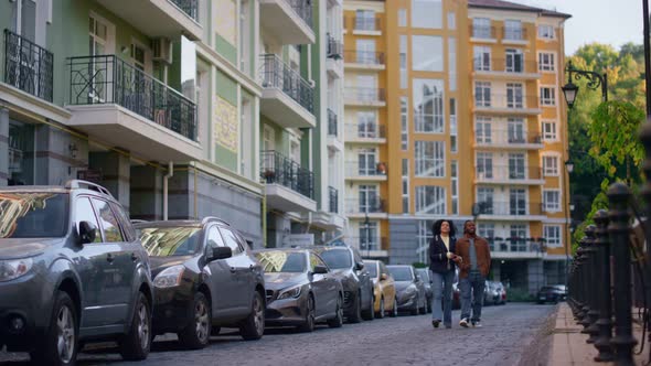 Romantic Couple Walking City Street on Spring Day alt