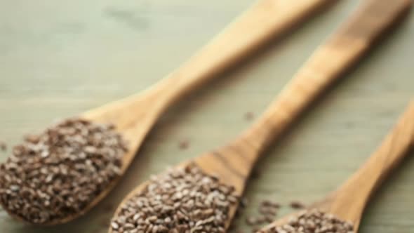 Flax seeds on painted wood board. alt