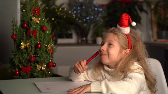 a Little Blonde Girl Writes a Letter to Santa Claus Gifts for Christmas a Happy Child alt
