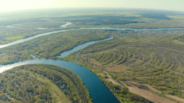 Aerial View Green Forest Woods And Curved River Landscape In Sunny Spring Day alt