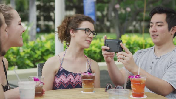 Group of friends in Hawaii taking photos with cell phone