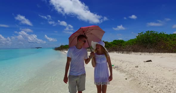 Happy lady and man on romantic honeymoon spend quality time on beach on paradise white sand 4K background alt