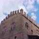 Ancient Palazzo Re Enzo Top Against Blue Sky in Bologna