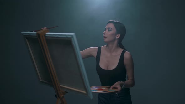 Girl Paints a Picture on the Easel