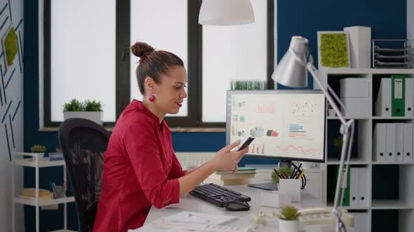 Financial Analyst Using Smartphone to Browse Internet Website alt