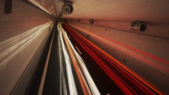 Light trails left by cars in the tunnel. Time stopped but camera is moving. 4K alt