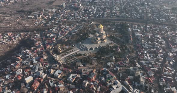 Aerial view of Holy Trinity Cathedral Sameba in Tbilisi Georgia. Sunrise drone footage. alt