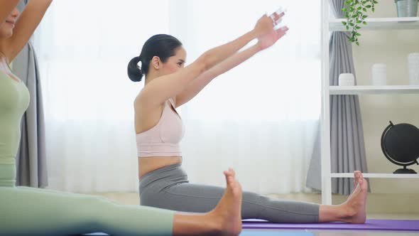 Asian active sport woman learn yoga pilates lesson with coach trainer. alt