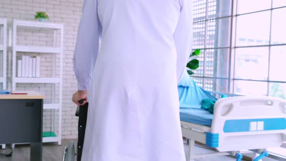 Doctor in Professional Uniform Examining Patient at Hospital alt