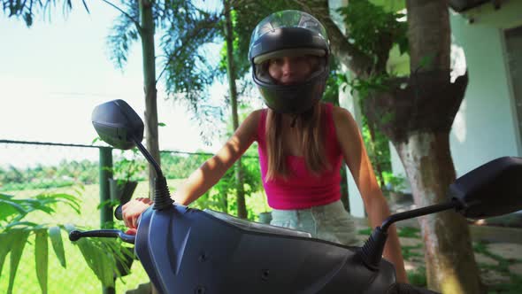 Young Woman Sitting in Helmet on the Bike Asia