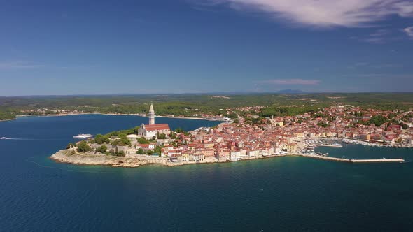 Flyby movie of the historical Croatian city Rovinj during daytime with clear skies alt