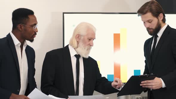 Three Smiling Diverse Business Colleagues Having Business Strategy Meeting alt