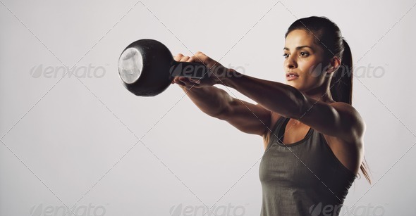Woman exercise with kettle bell - Crossfit workout - Stock Photo - Images