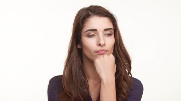 Thoughtful Attractive Young Caucasian Female in Dark Blue Shirt with Long Brown Hairstanding on alt