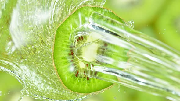 Super Slow Motion Shot of Splashing Water on Rotating Kiwi Slice at 1000Fps alt