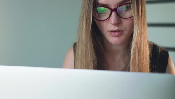 Portrait of Serious Woman Working with Laptop and Thinking alt