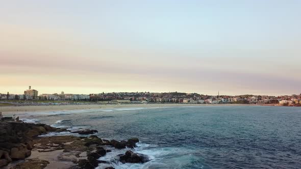 Aerial drone shot of Bondi Beach coastline at sunset 4k alt