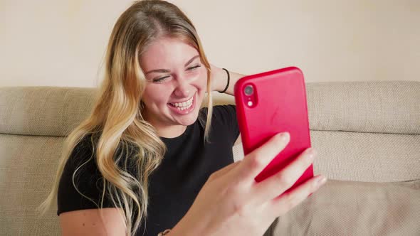 Smiling blonde woman having video call, Italy