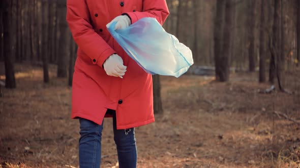 Cleaner Woman Collecting Trash In Forest. Trash Volunteer Eco Activist. Picking Tidying Trash. alt