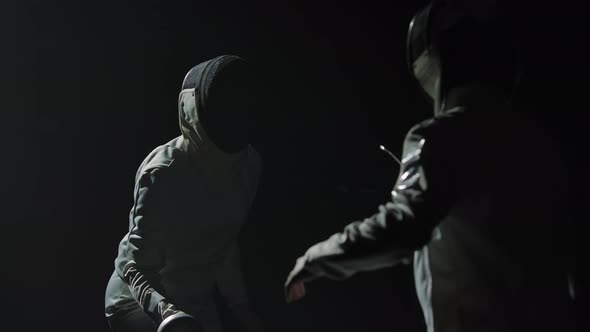 Two Professional Fencers Demonstrate Their Mastery of Foil Fencing alt