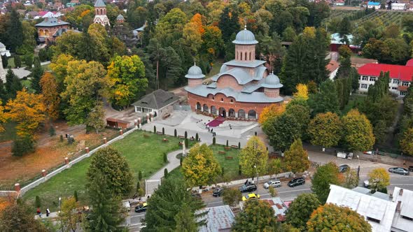 Aerial drone view of The Monastery of Curtea de Arges, Romania. Square with greenery alt
