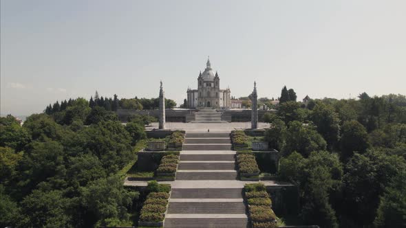 Cinematic pull out shot away from Sameiro Sanctuary complex and stairway in Braga Portugal. alt
