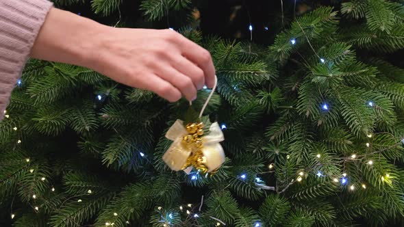 Female Hand Decorating Christmas Tree alt