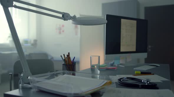 Working Computer Standing Doctor Desktop in Empty Medical Cabinet Close Up alt