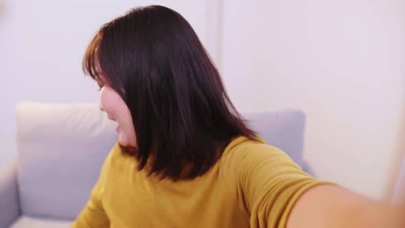 Asian women happy and smile making video call with friends showing credit cards and cell phones afte alt