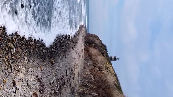 Vertical orientation video: Lighthouse on the sea coast