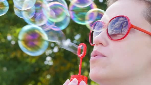 Woman blow bubbles and laughs alt