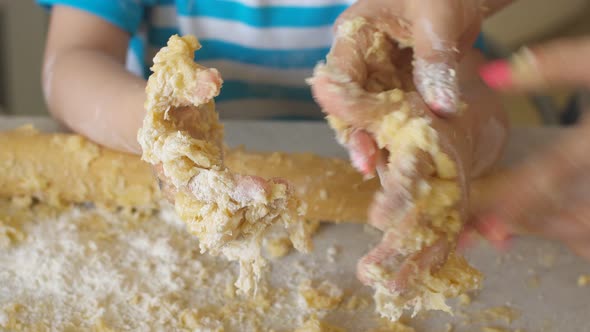 Children Kneading Dough in the Kitchen and Smeared in Flour.