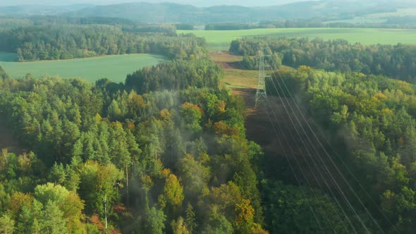 Flight Along High Voltage Power Lines and High Voltage Electric Transmission Tower or Pylon on the alt